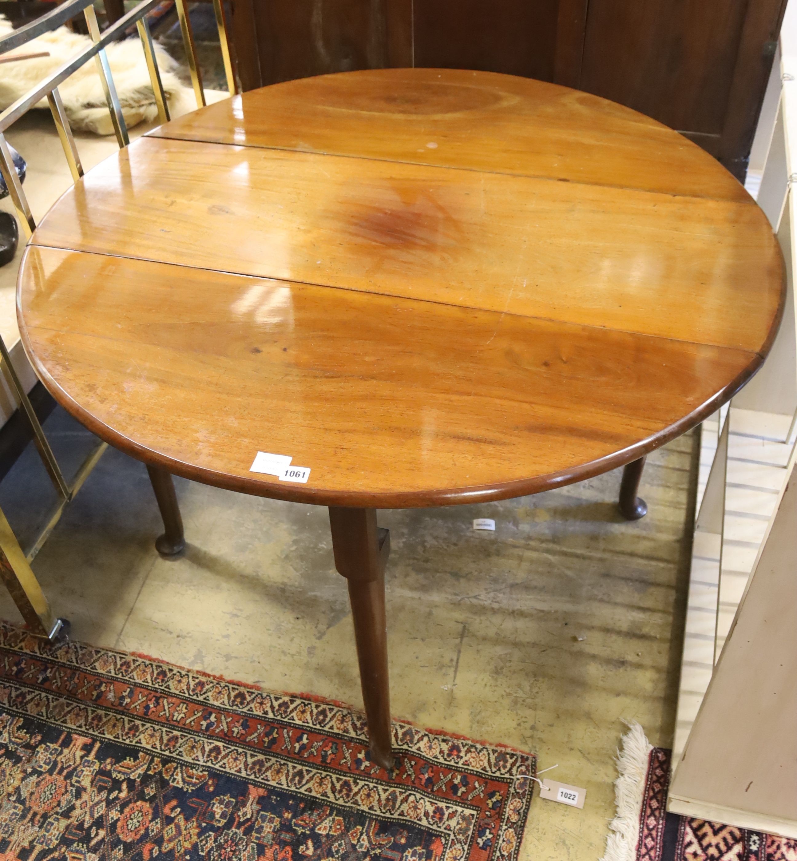 A George III mahogany oval pad foot drop leaf dining table, 116cm extended, 70cm height